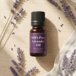 bottle of lavender oil on table with lavender around it